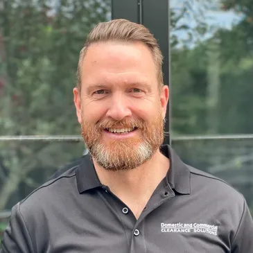 Lee smiling directly at the camera.